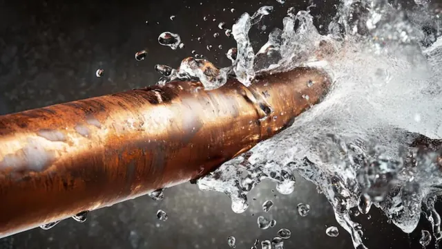 Split copper pipe spraying water