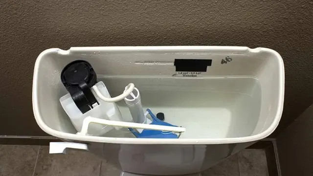 Open toilet tank showing the flapper and fill valve